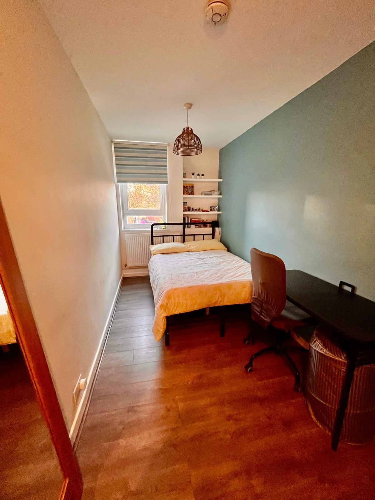 Double bedroom with desk, shelves and large window